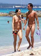 Young nudist friends naked together at the beach