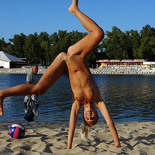 Barely legal young nudist lays naked at the beach